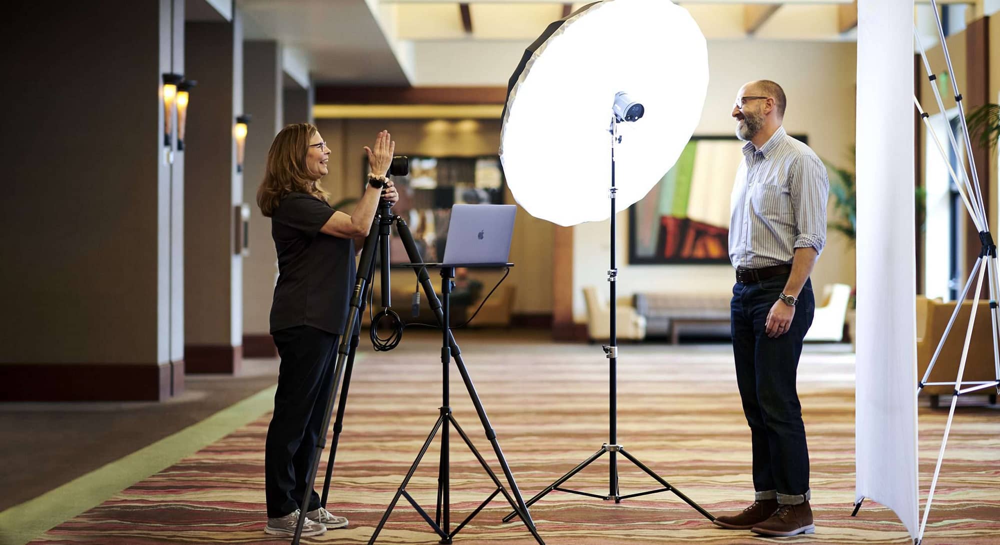 Image of a man getting a headshot at a event at a hotel